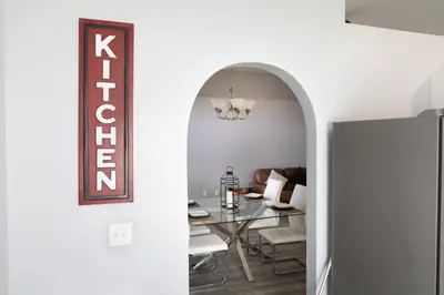 a dining room with a table and a sign on the wall at Florida Suburban Oasis ~ Lk Mary/Sanford Florida! in Sanford