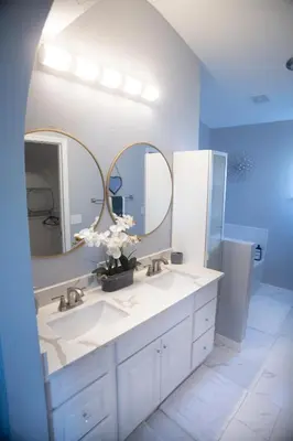 a bathroom with two sinks and a large mirror at Florida Suburban Oasis ~ Lk Mary/Sanford Florida! in Sanford