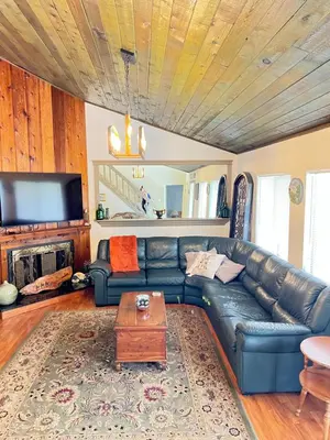 a living room with a leather couch and a table at Spacious and relaxing Home - Longwood, Florida in Orlando