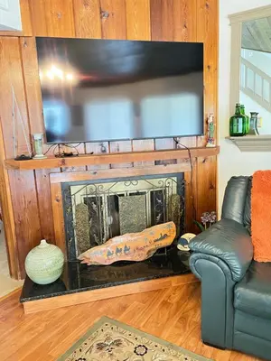 a living room with a fireplace with a flat screen tv at Spacious and relaxing Home - Longwood, Florida in Orlando