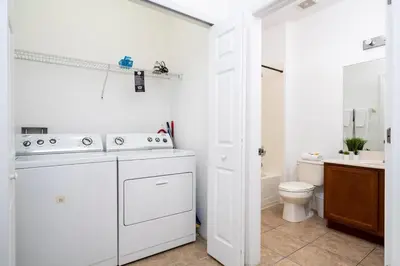 a white bathroom with a sink and a toilet at Four Bedroom w/ Screened Pool Close to Disney 4572 in Kissimmee