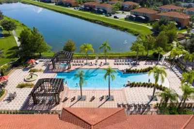 an aerial view of a pool at a resort at Four Bedroom w/ Screened Pool Close to Disney 4572 in Kissimmee