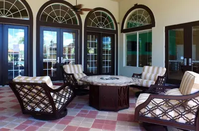 a room with a table and chairs and windows at Four Bedroom w/ Screened Pool Close to Disney 4572 in Kissimmee