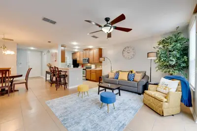 a living room with a couch and a dining room at 15 Mi to Disney Kissimmee Townhome with Patio in Kissimmee