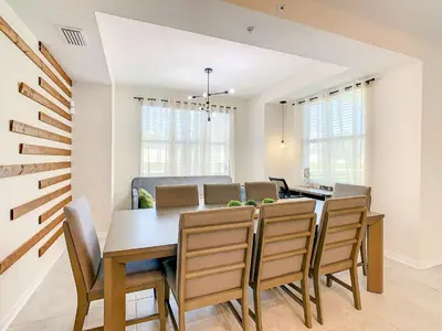 a dining room with a table and chairs at Wonderful 2BR Condo with 2 Clubhouses in Kissimmee