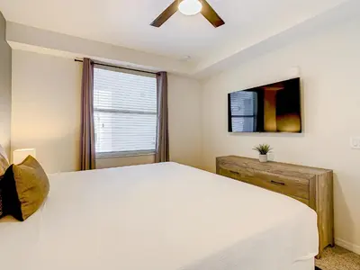 a bedroom with a large white bed and a window at Wonderful 2BR Condo with 2 Clubhouses in Kissimmee