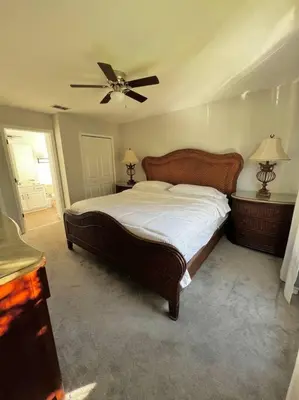 a bedroom with a bed and a ceiling fan at Emerald Island Private Pool Home near Disney in Kissimmee