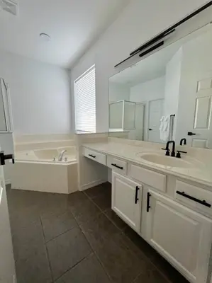 a bathroom with a sink and a large mirror at Emerald Island Private Pool Home near Disney in Kissimmee