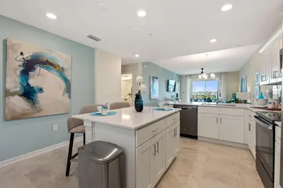 a large kitchen with white cabinets and a counter top at Resort Life at Storey Lake by Shine Villas, #702 apts in Kissimmee