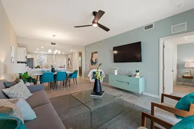 a living room with a couch and a dining room at Resort Life at Storey Lake by Shine Villas, #702 apts in Kissimmee