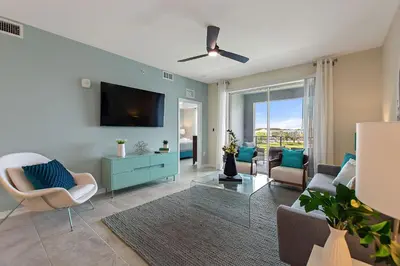a living room with a couch and a tv at Resort Life at Storey Lake by Shine Villas, #702 apts in Kissimmee