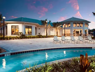 a house with a swimming pool in front of a house at Sweet Suite Sleeps 6 Storey Lake by Shine Villas apts in Kissimmee