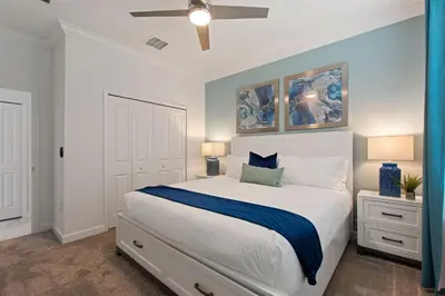 a bedroom with a large white bed and two lamps at Stars Align Storey Lake by Shine Villas villa in Kissimmee
