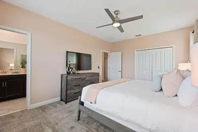 a bedroom with a bed and a ceiling fan at Stars Align Storey Lake by Shine Villas villa in Kissimmee