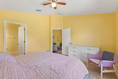 a bedroom with a bed and a ceiling fan at Gilded Parasol by Shine Villas Remington Golf #410 home in Kissimmee