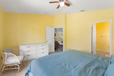 a bedroom with a bed and a ceiling fan at Gilded Parasol by Shine Villas Remington Golf #410 home in Kissimmee