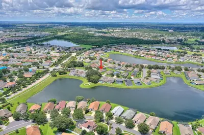 an aerial view of a suburb with two lakes at Gilded Parasol by Shine Villas Remington Golf #410 home in Kissimmee