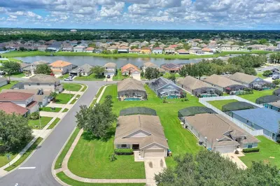 an aerial view of a residential suburb with a street at Gilded Parasol by Shine Villas Remington Golf #410 home in Kissimmee