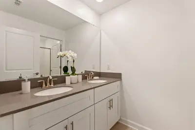 a bathroom with two sinks and a large mirror at Blue Beach at Storey Lake by Shine Villas #400 townhouse in Kissimmee