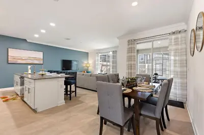 a dining room and living room with a dining table at Blue Beach at Storey Lake by Shine Villas #400 townhouse in Kissimmee