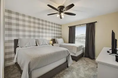 a bedroom with two beds and a ceiling fan at Barefoot Breeze - Storey Lake by Shine Villas #833 townhouse in Kissimmee