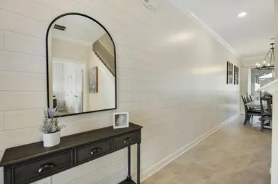 a hallway with a mirror and a dresser at Barefoot Breeze - Storey Lake by Shine Villas #833 townhouse in Kissimmee