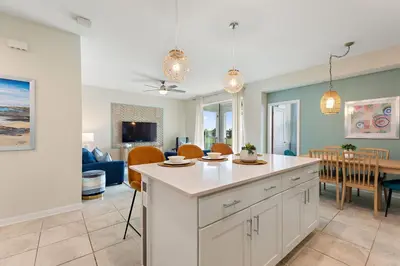 a kitchen and living room with a table and chairs at Serenity Haven, Bliss, Storey Lake by Shine Villas condo in Kissimmee