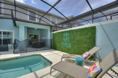 a house with a swimming pool and a patio at Haven Station at Storey Lake by Shine Villas townhouse in Kissimmee