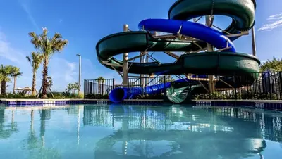a water slide in a swimming pool at Happy Haven at Storey Lake Resort by Shine Villas condo in Kissimmee