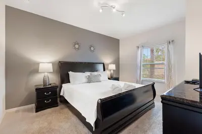 a bedroom with a large bed and a window at Lucky Find Lucaya Resort by Shine Villas #713 townhouse in Kissimmee