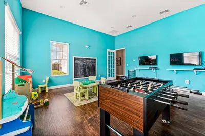 a room with blue walls and a pool table at Lucky Find Lucaya Resort by Shine Villas #713 townhouse in Kissimmee