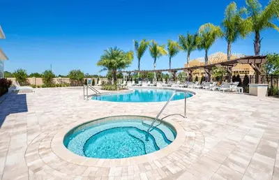 a swimming pool in a courtyard with palm trees at Lucky Find Lucaya Resort by Shine Villas #713 townhouse in Kissimmee