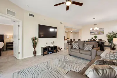 a living room with a couch and a flat screen tv at Triple Header Storey Lake by Shine Villas apts in Kissimmee