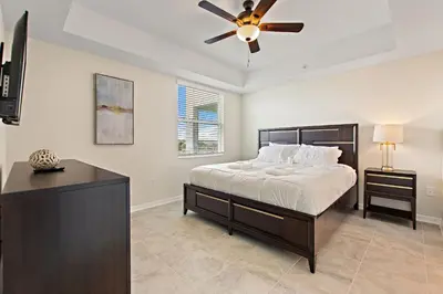 a bedroom with a bed and a ceiling fan at Triple Header Storey Lake by Shine Villas apts in Kissimmee