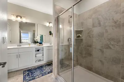 a bathroom with a walk in shower and a sink at Lake View at Storey Lake by Shine Villas #703 apts in Kissimmee