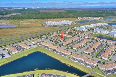 an aerial view of a city with buildings and water at Lazy Life at Storey Lake by Shine Villas #901 condo in Kissimmee