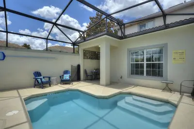 a swimming pool in a house with a glass roof at Lazy Life at Storey Lake by Shine Villas #901 condo in Kissimmee