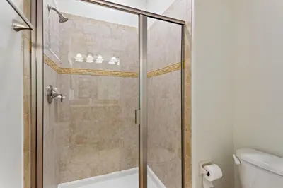 a shower with a glass door in a bathroom at Lazy Life at Storey Lake by Shine Villas #901 condo in Kissimmee