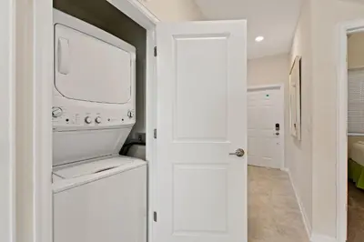 a white laundry room with a washer and dryer at Tranquility at Storey Lake by Shine Villas #828 apts in Kissimmee