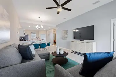 a living room with a couch and a table at Edgewater Escape at Storey Lake by Shine Villas apts in Kissimmee