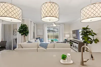 a living room with a couch and a tv at Plush Pelican, at Storey Lake by Shine Villas #839 home in Kissimmee