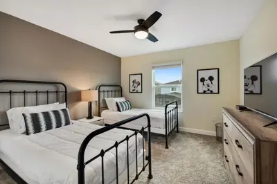 a bedroom with two beds and a ceiling fan at Magic Lily - Storey Lake by Shine Villas #834 townhouse in Kissimmee