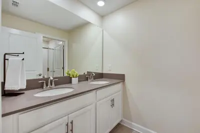 a bathroom with two sinks and a mirror at Magic Lily - Storey Lake by Shine Villas #834 townhouse in Kissimmee