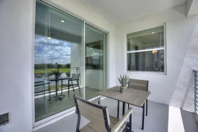 a dining room with a table and chairs and a window at Decadent Penguin - Storey Lake by Shine Villas 704 apts in Kissimmee
