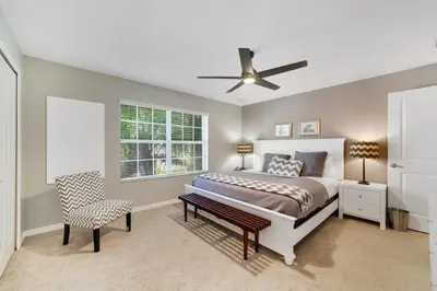 a bedroom with a bed and a ceiling fan at Star Hideaway at Storey Lake by Shine Villas townhouse in Kissimmee