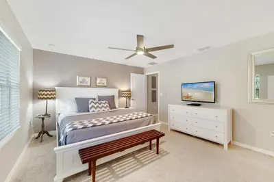 a bedroom with a bed and a ceiling fan at Star Hideaway at Storey Lake by Shine Villas townhouse in Kissimmee