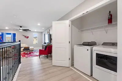 a kitchen with a washer and dryer in a room at Water Kingdom Storey Lake by Shine Villas! #525 home in Kissimmee