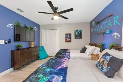 a bedroom with two beds and a ceiling fan at Water Kingdom Storey Lake by Shine Villas! #525 home in Kissimmee