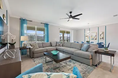 a living room with a couch and a table at Water Kingdom Storey Lake by Shine Villas! #525 home in Kissimmee