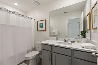 a white bathroom with a sink and a toilet at Sea Shore at Solara Resort by Shine Villas #401 villa in Orlando